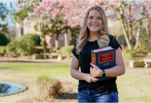 ABAC student holding Constitutional Law book
