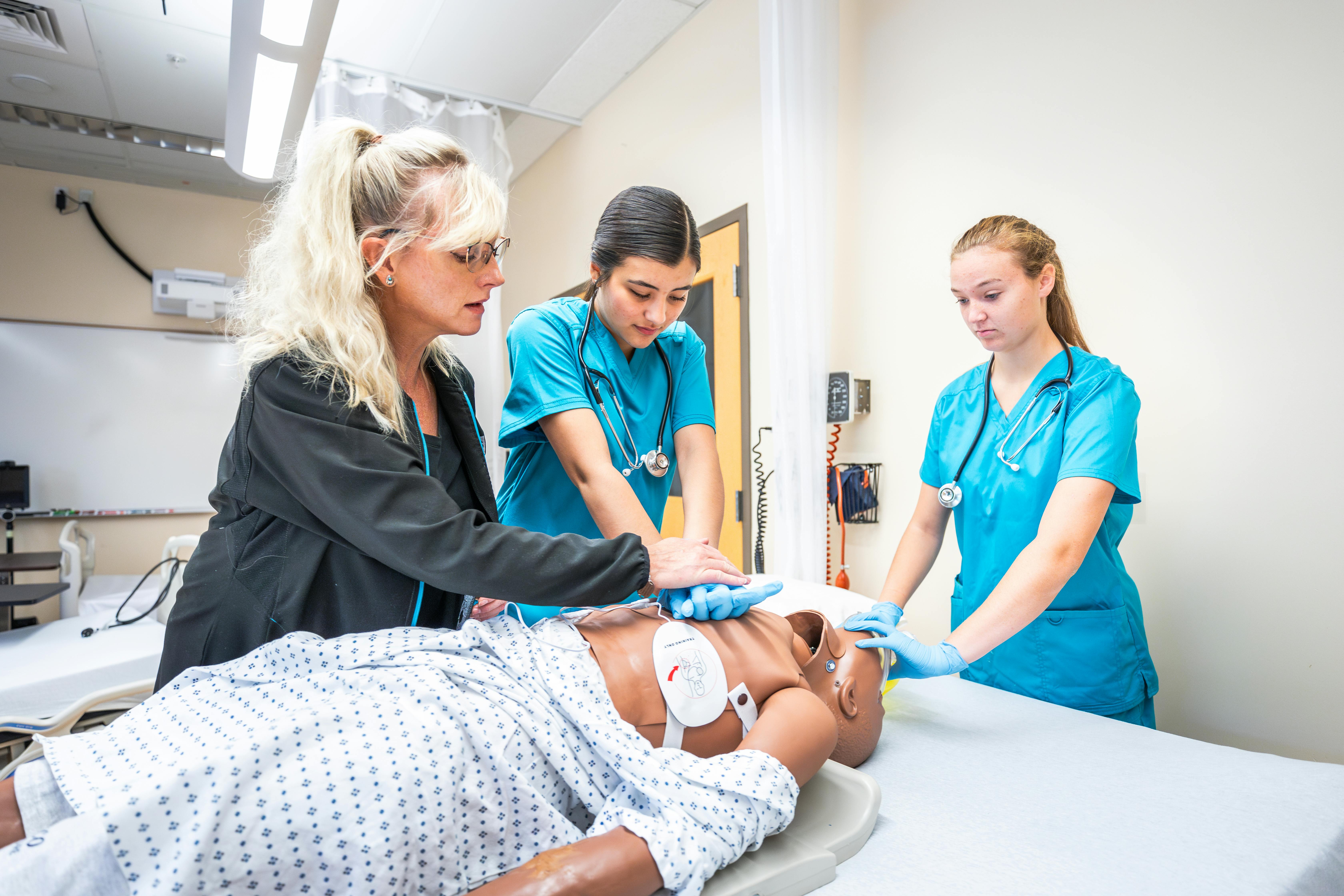 Aims Acute Care Nurse Aide students practicing patient care in a lab
