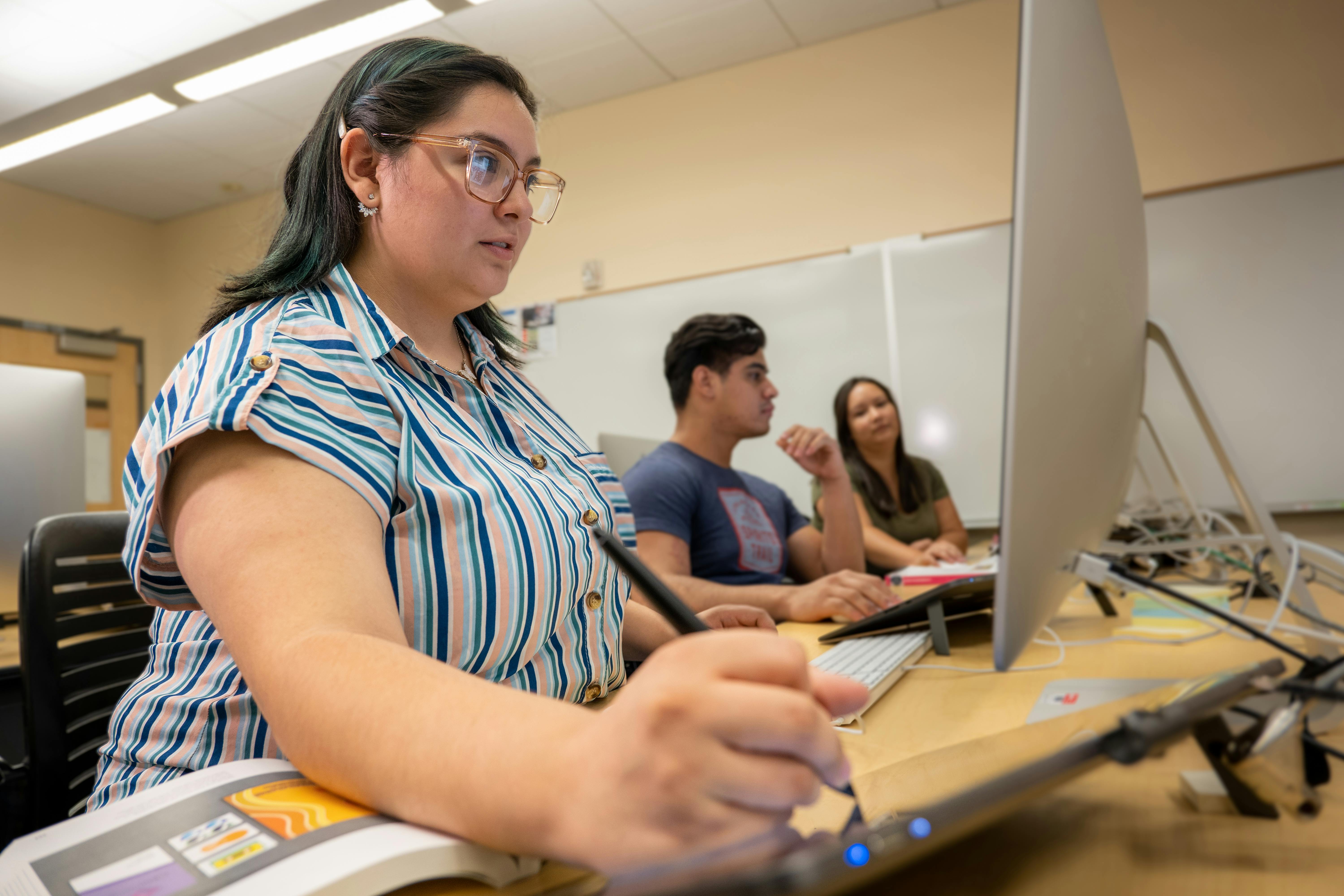 Aims students working in a computer lab