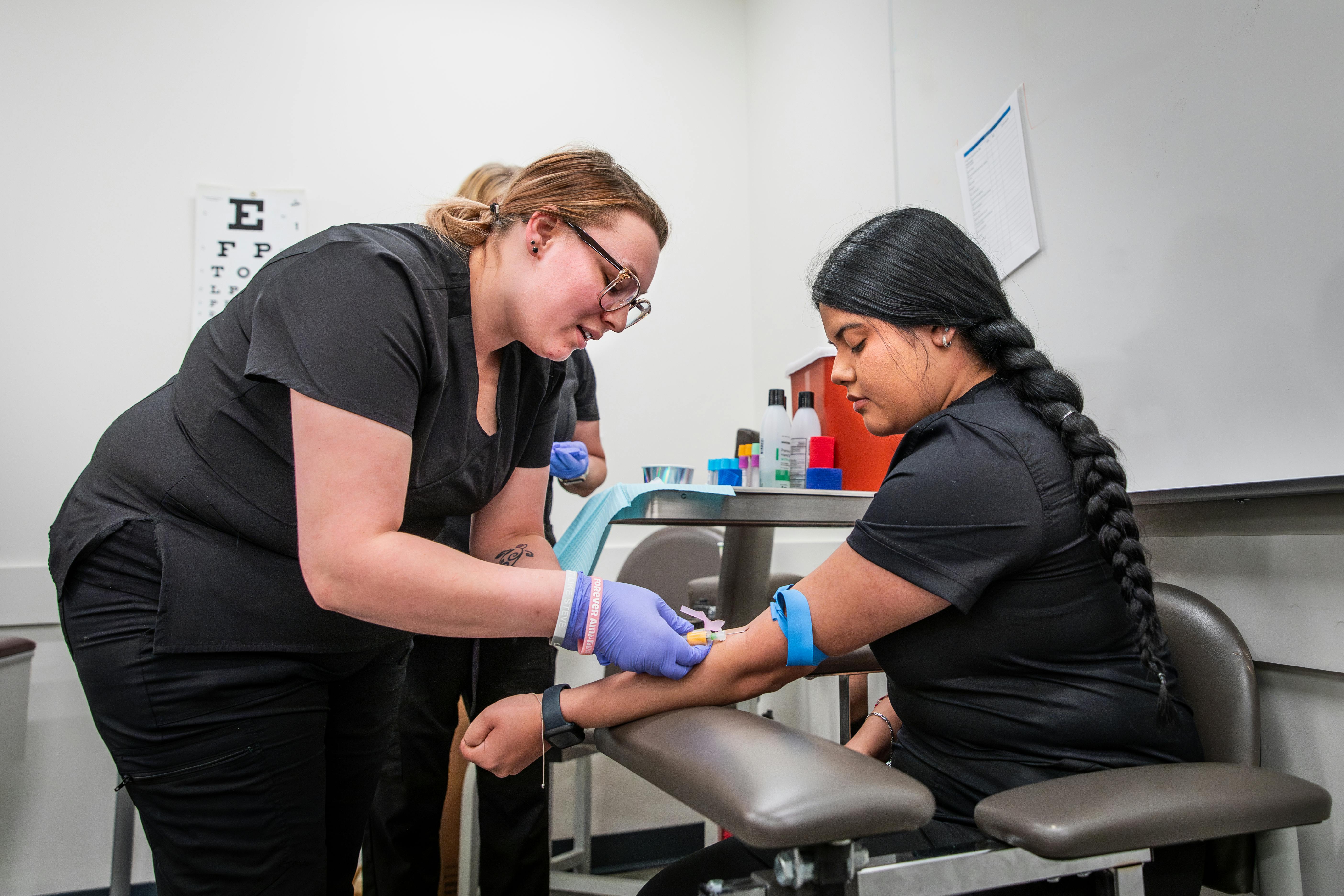 Phlebotomy Certificate students practicing in a lab setting at Aims Community College