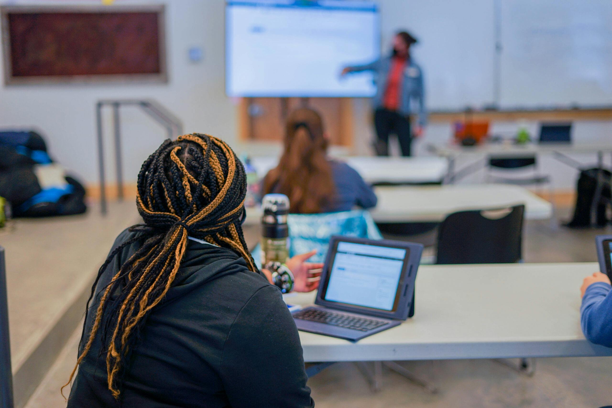 elm-pg-billboard-cta 1 - Student-in-class-teacher-scaled