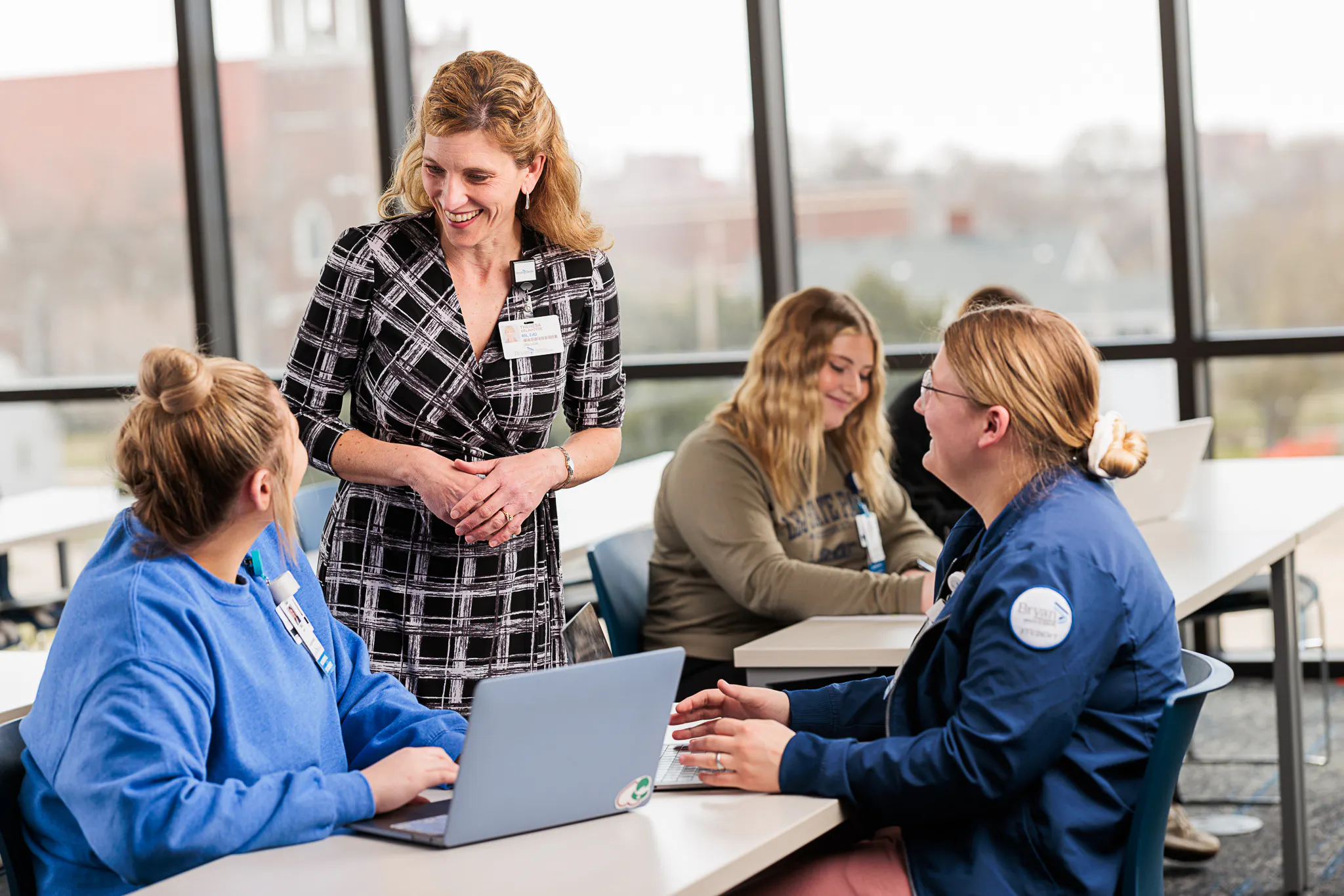 Dean of Nursing interacting with students during a lecture.