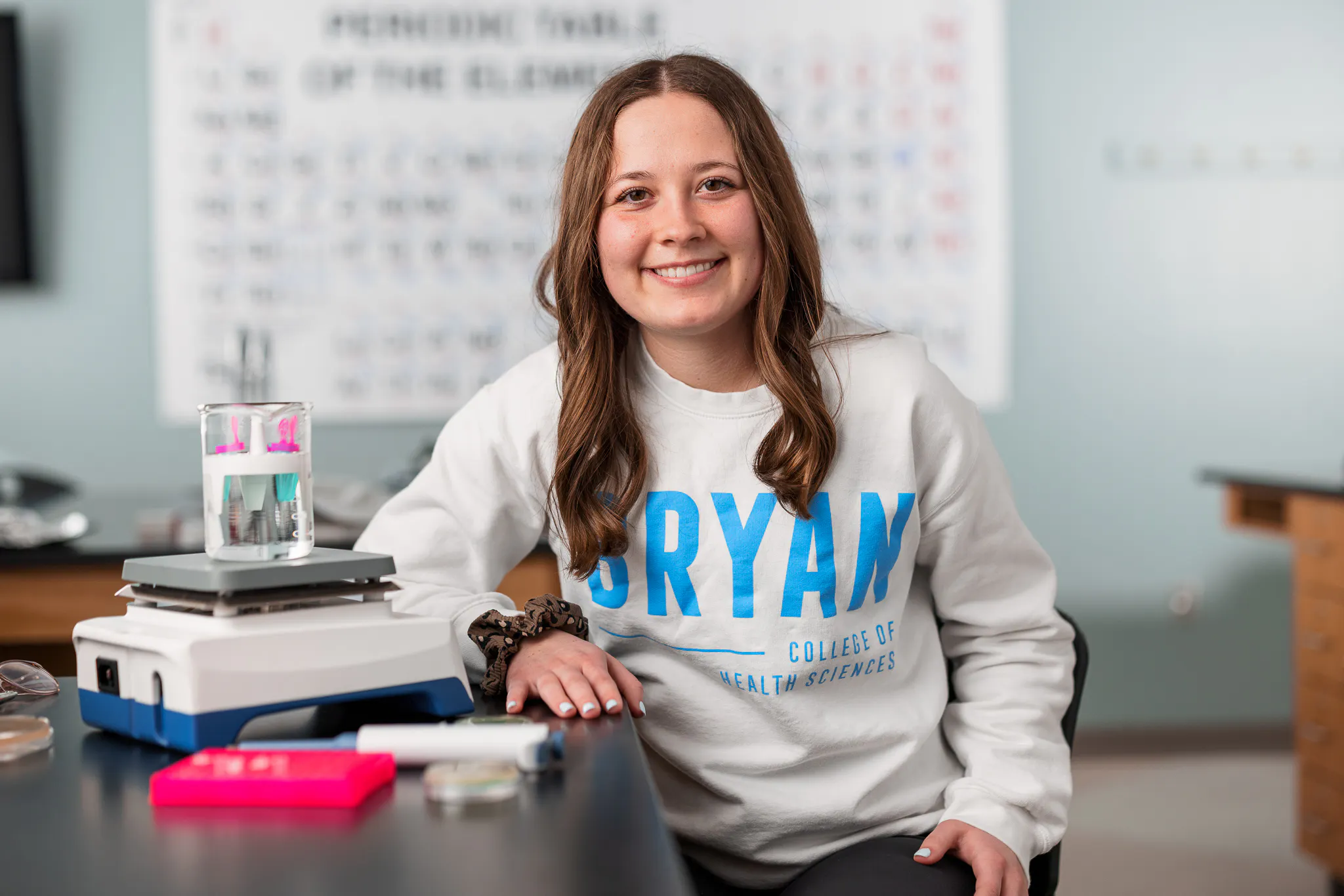 BCHS female student sitting in science lab. Smiling into camera.
