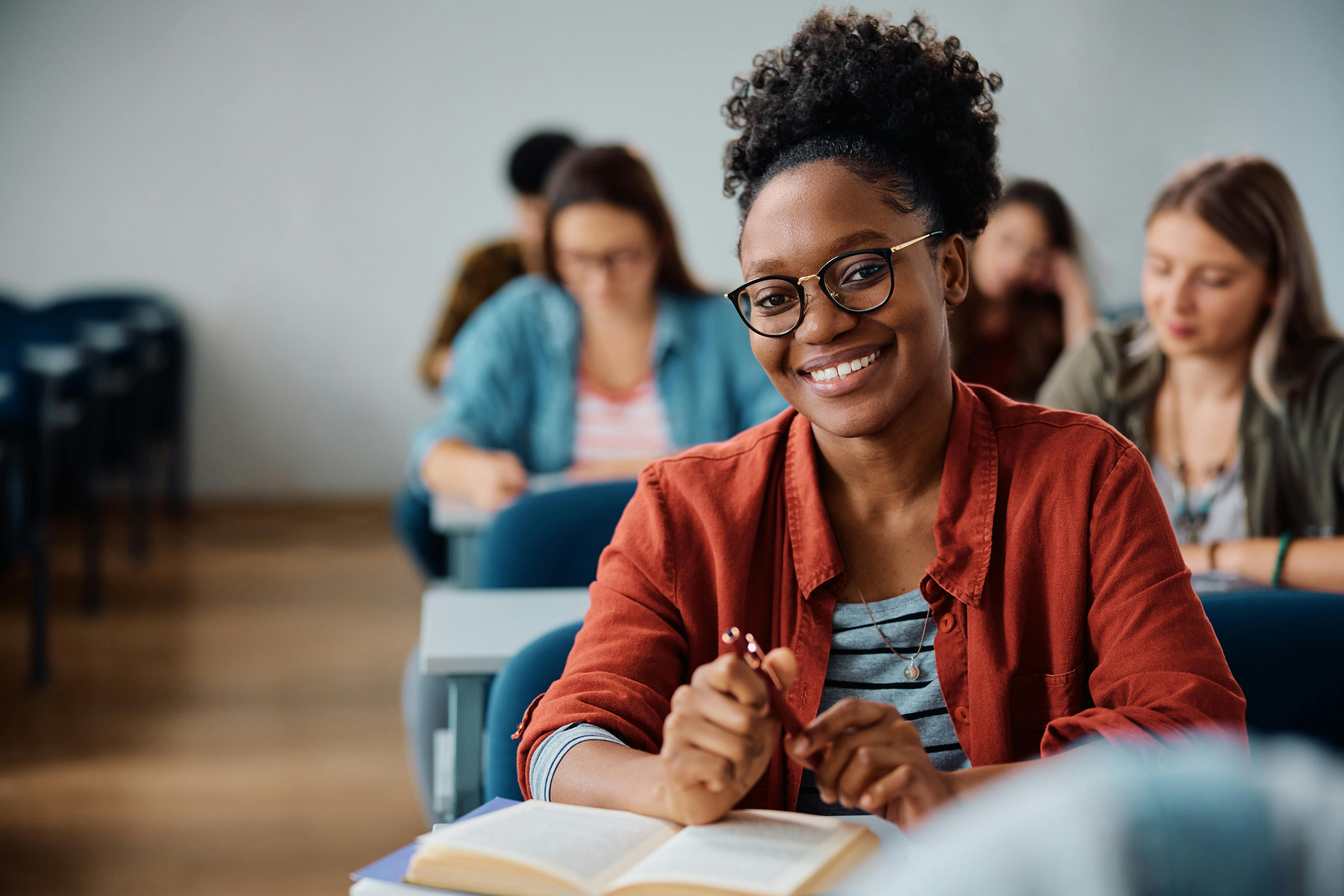 student in classroom smiling