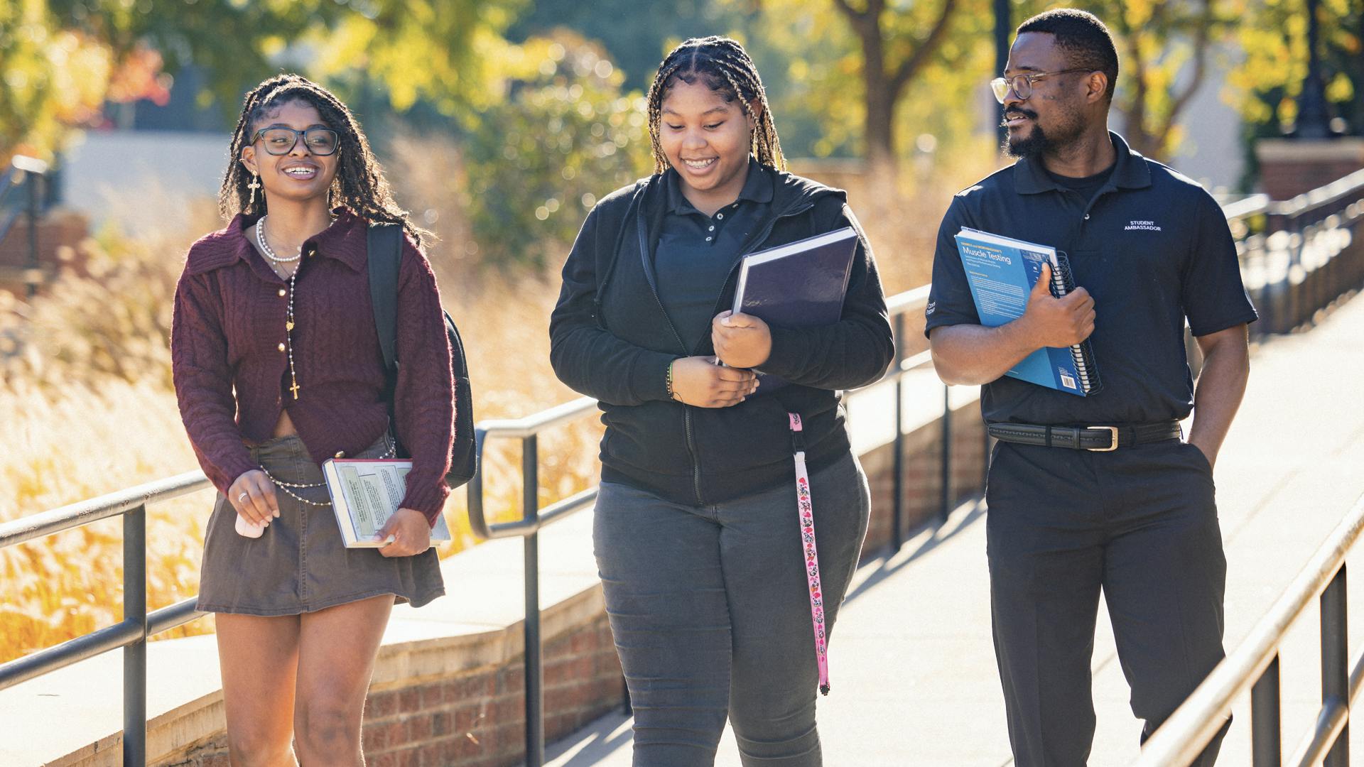 Three students walking outside on campus