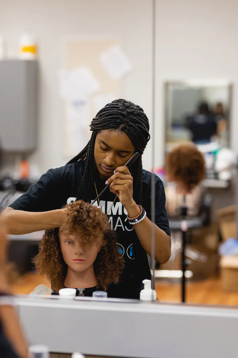 Central Piedmont student providing natural hair care