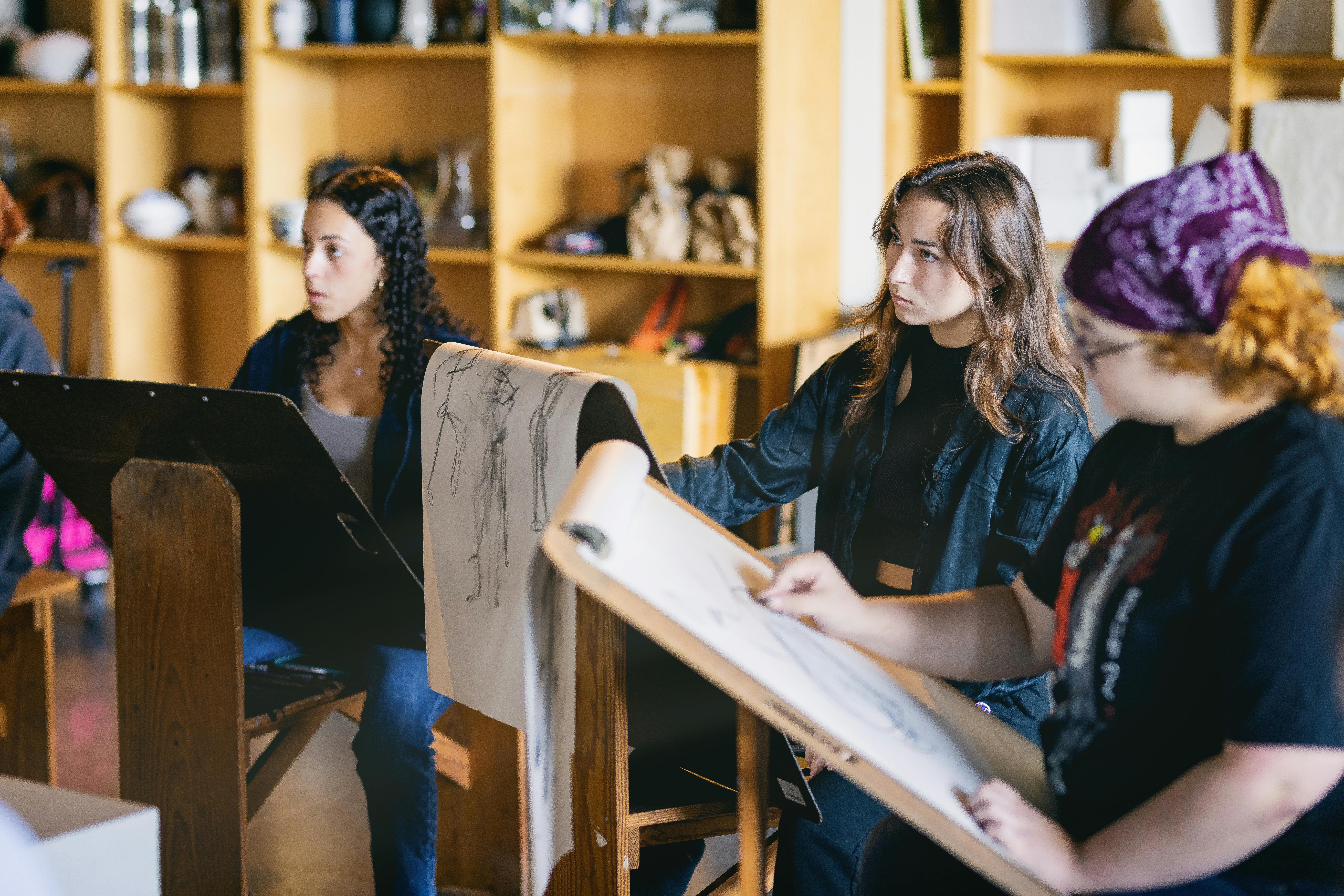 three students in art class