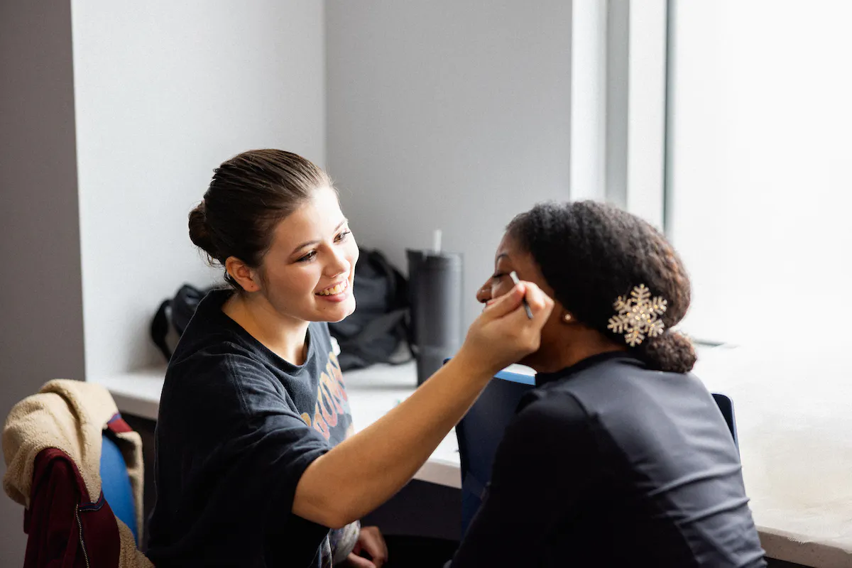 Cosmetology program student who is specializing in aesthetics providing make up support