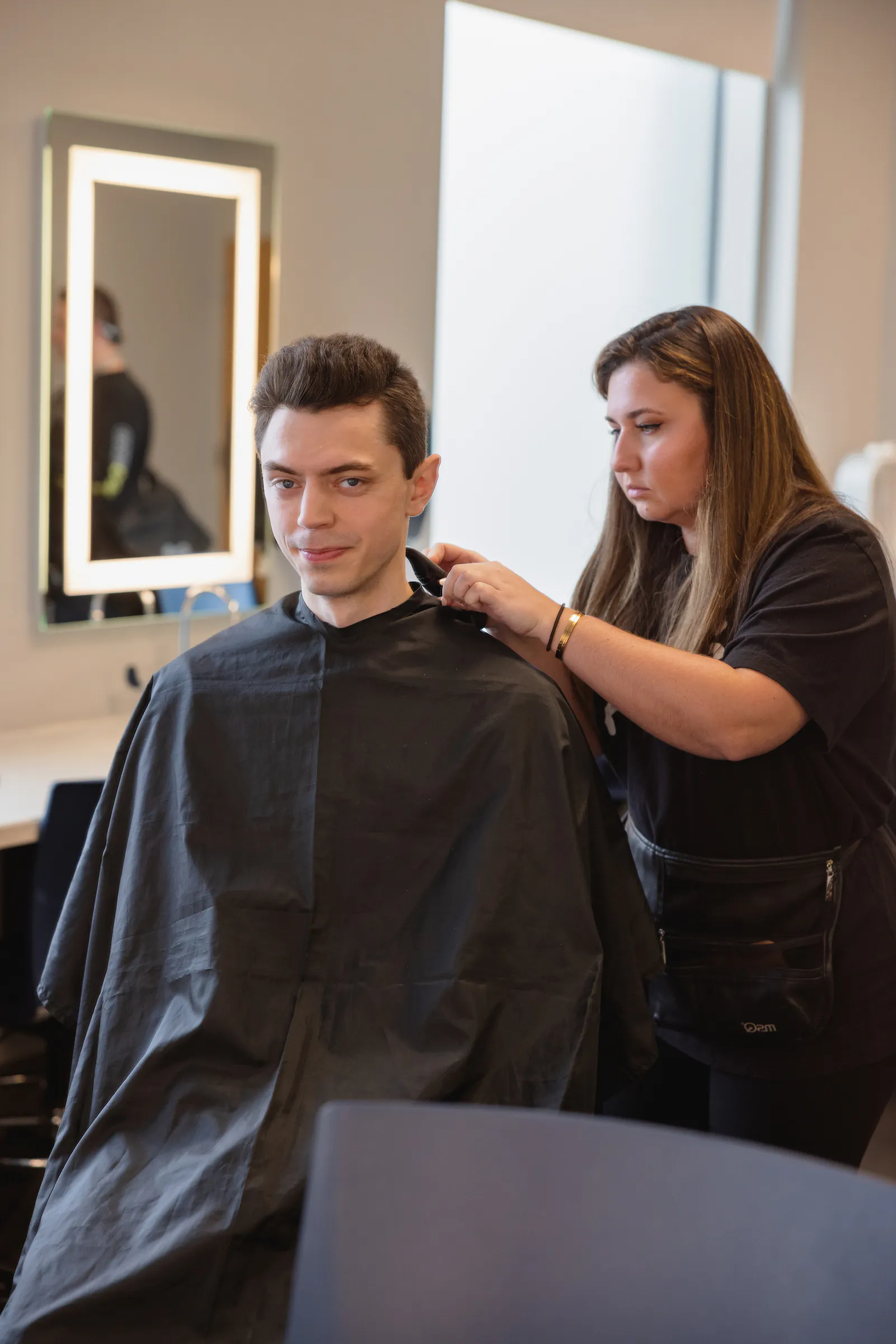 Central Piedmont Community College barbering student giving a haircut