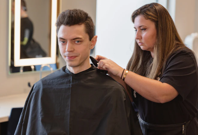 Central Piedmont Community College barbering student giving a haircut