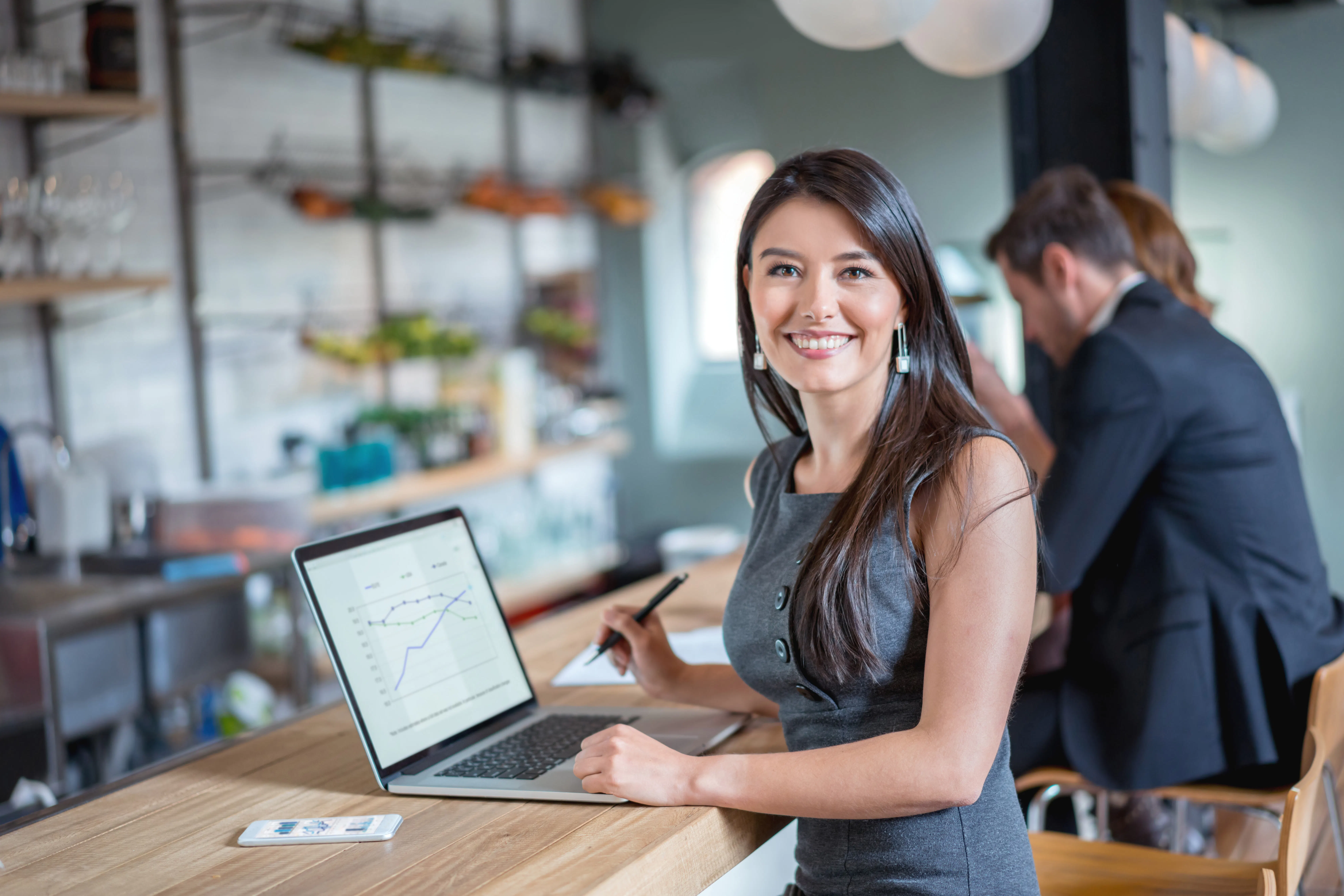 A female tax professional working at a cafe.