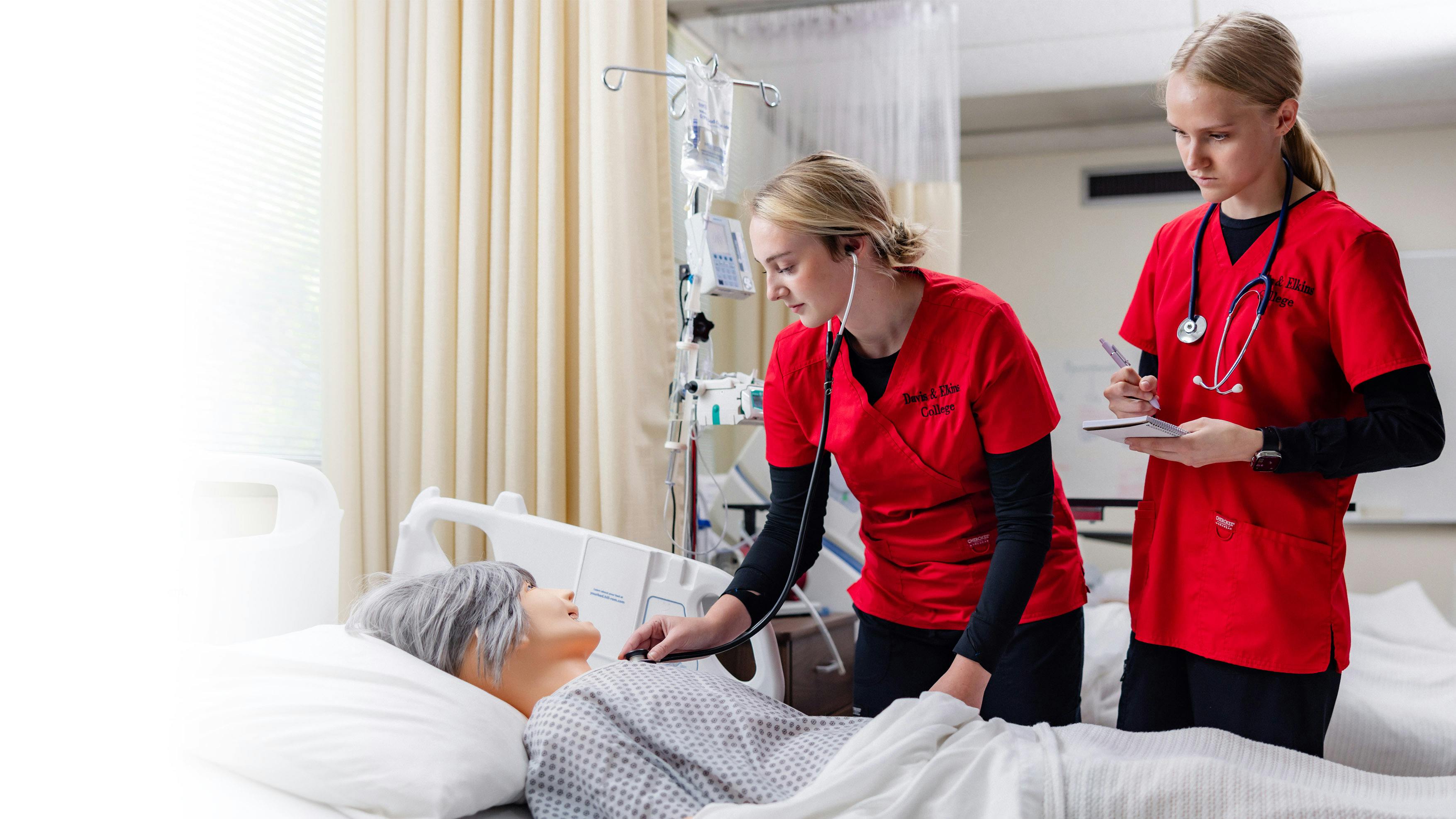 Nursing students tend to a patient in the SIM classroom