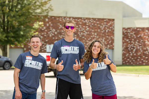 Faith students giving a thumbs up to the new students