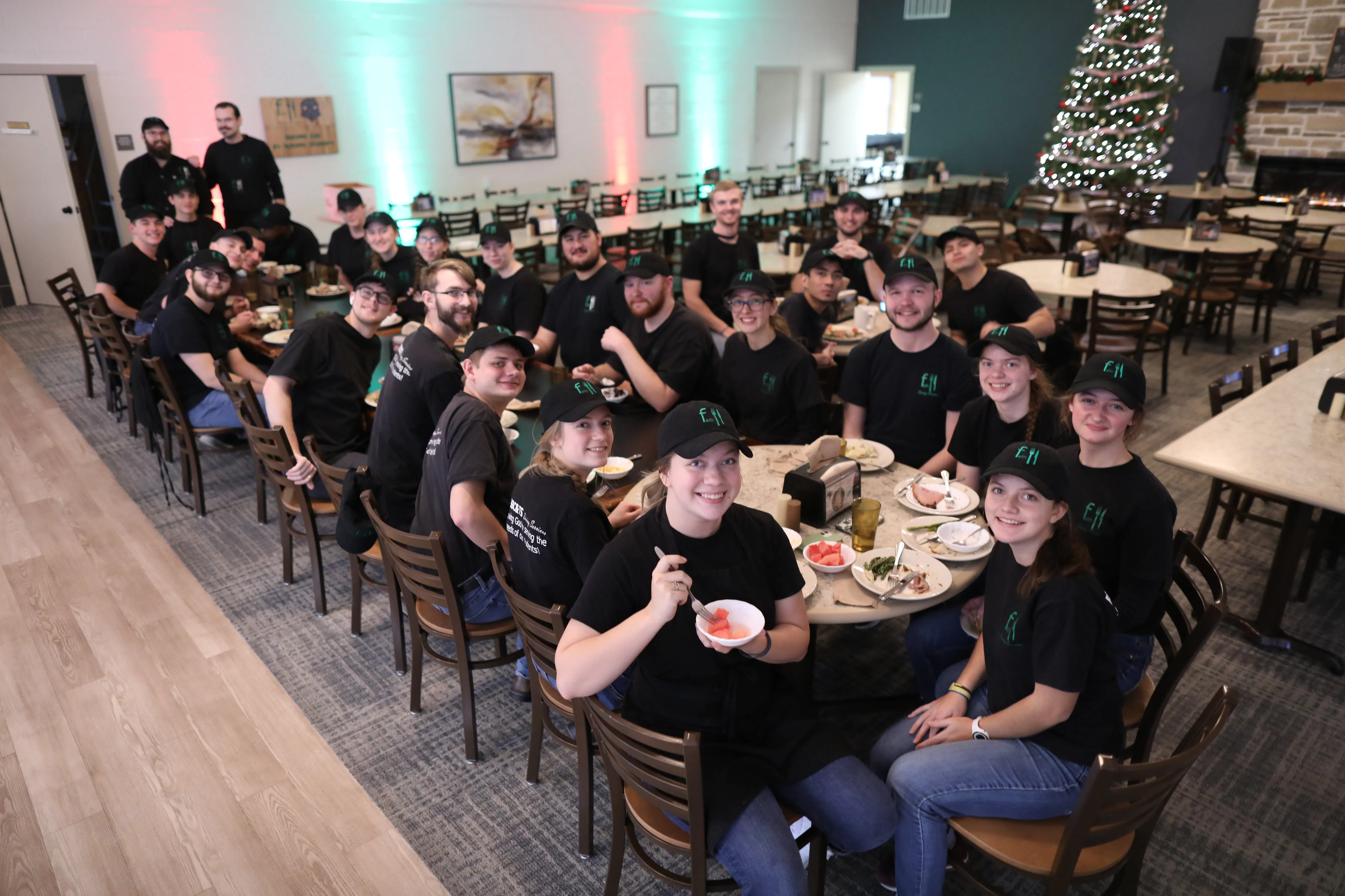 Smiling dining service workers at a table