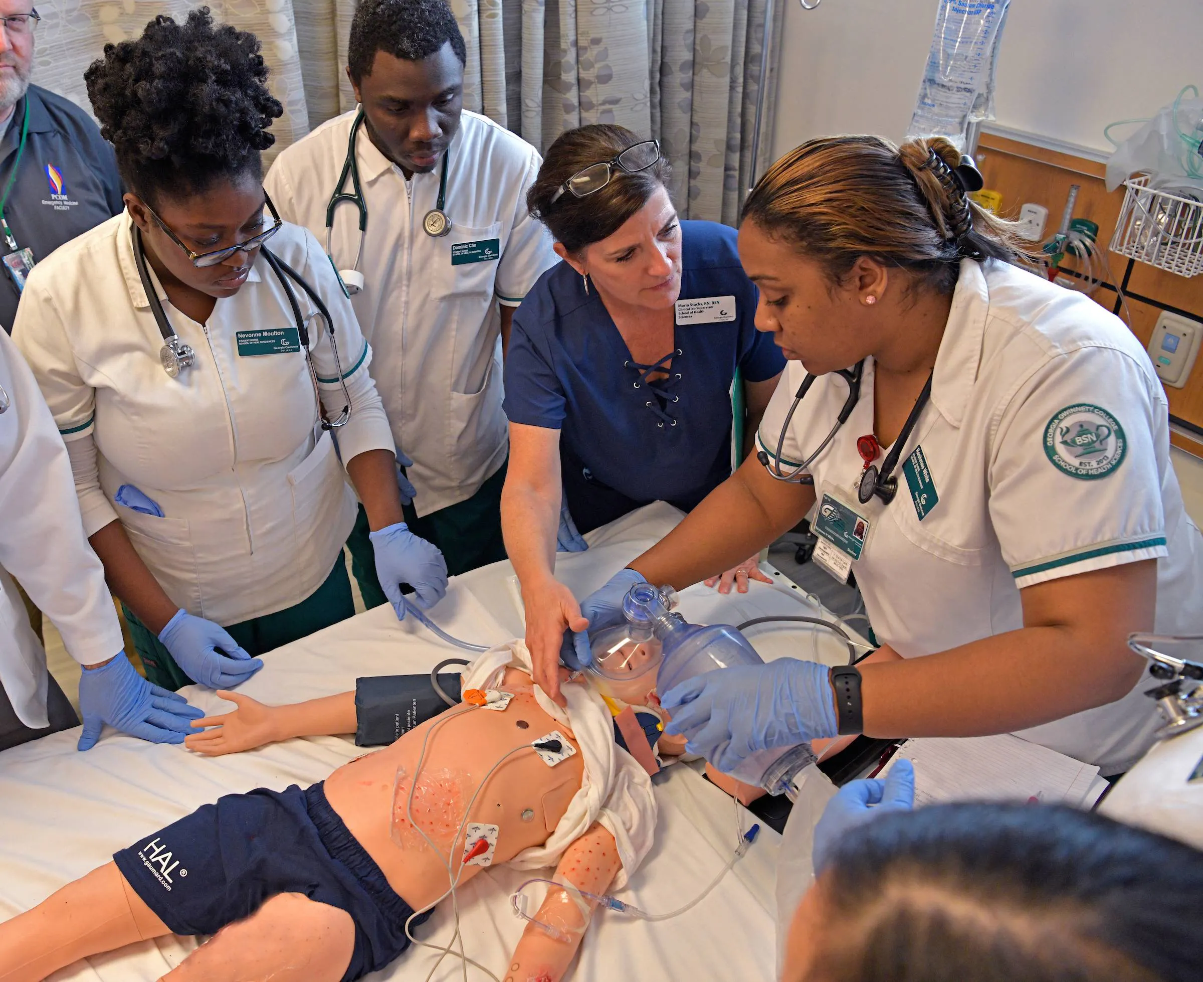 nursing students practicing on a mannequin