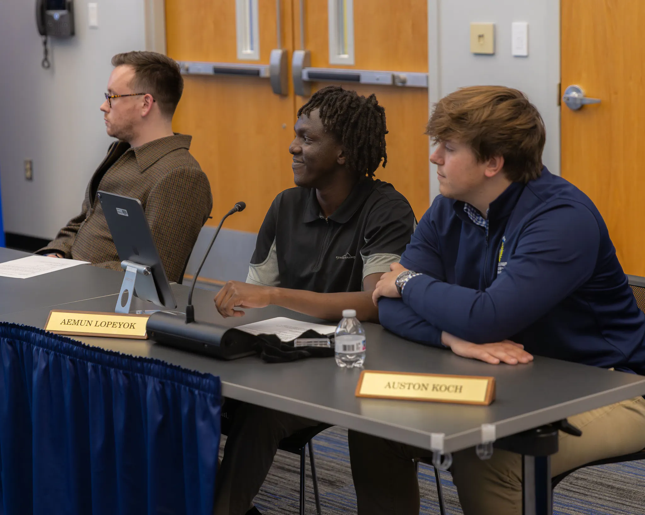 Image from a Heartland Board of Trustee meeting, showing trustee Josh Crockett, student trustee Aeman Lopeyok and former student trustee, Auston Koch.