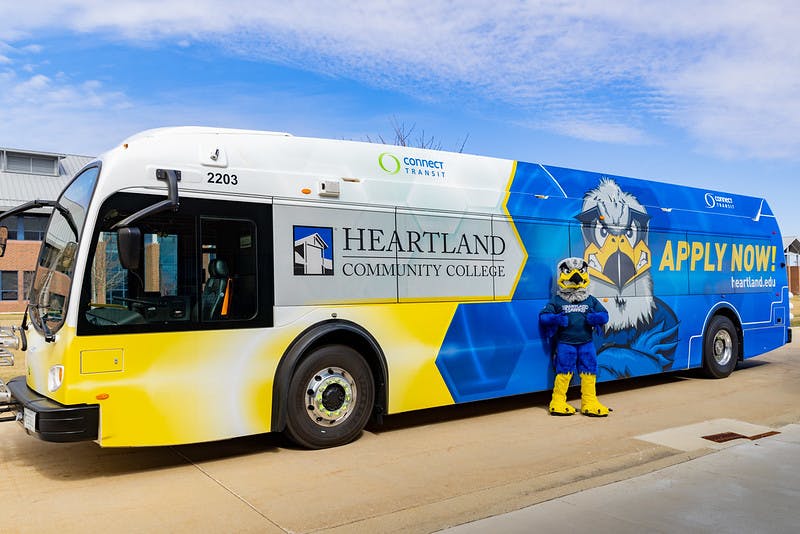 mascot hunter standing with bus