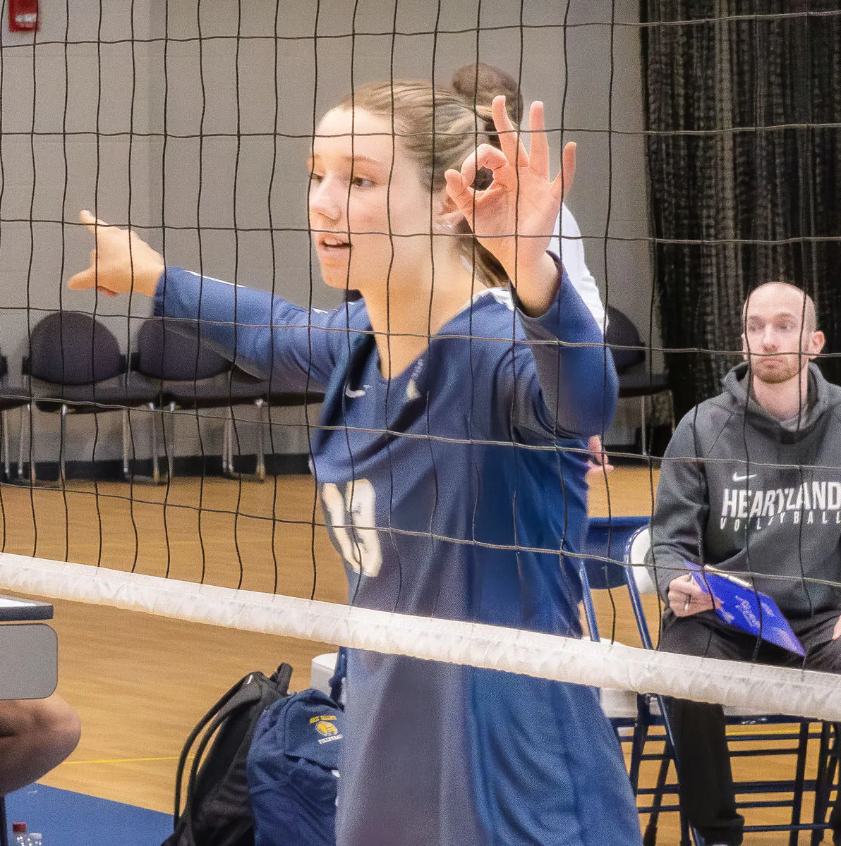 Mairen Mannon at the volleyball net at a game