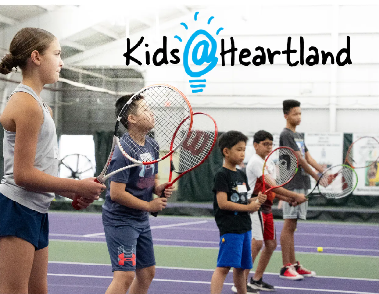 Children with tennis rackets with Kids@Heartland title.