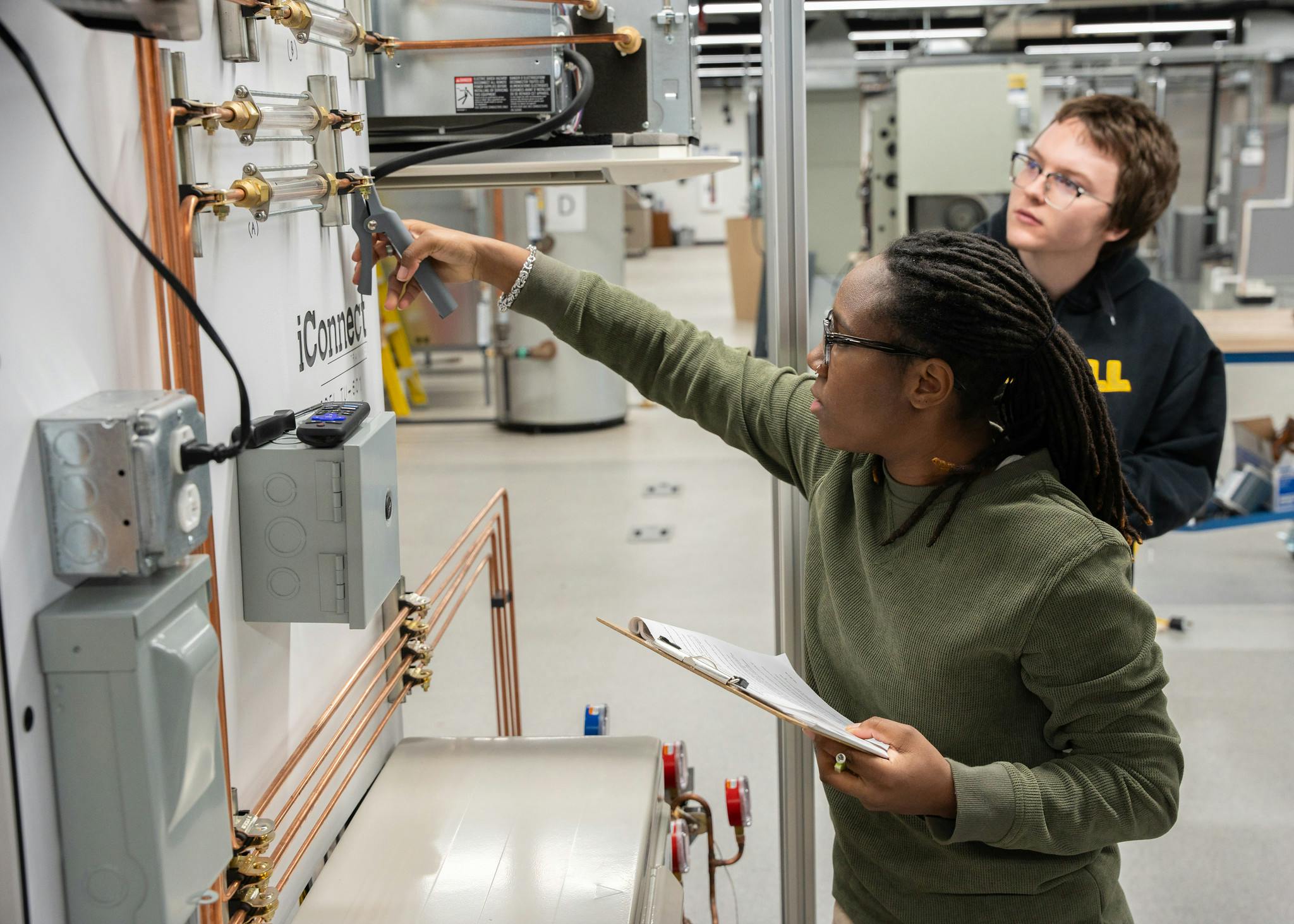 students working on a machine in HVAC classes. 