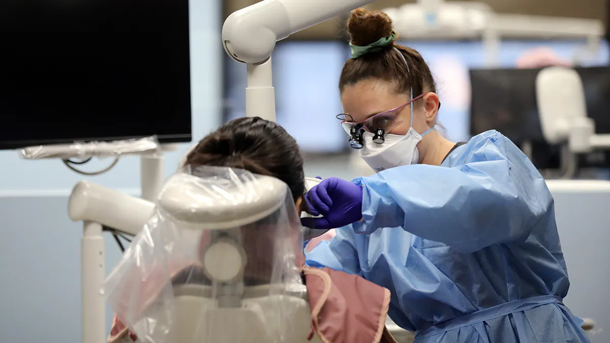Dental Hygiene student performs an examination.