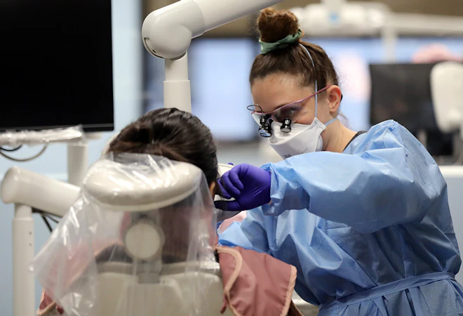 Dental Hygiene student performs an examination.