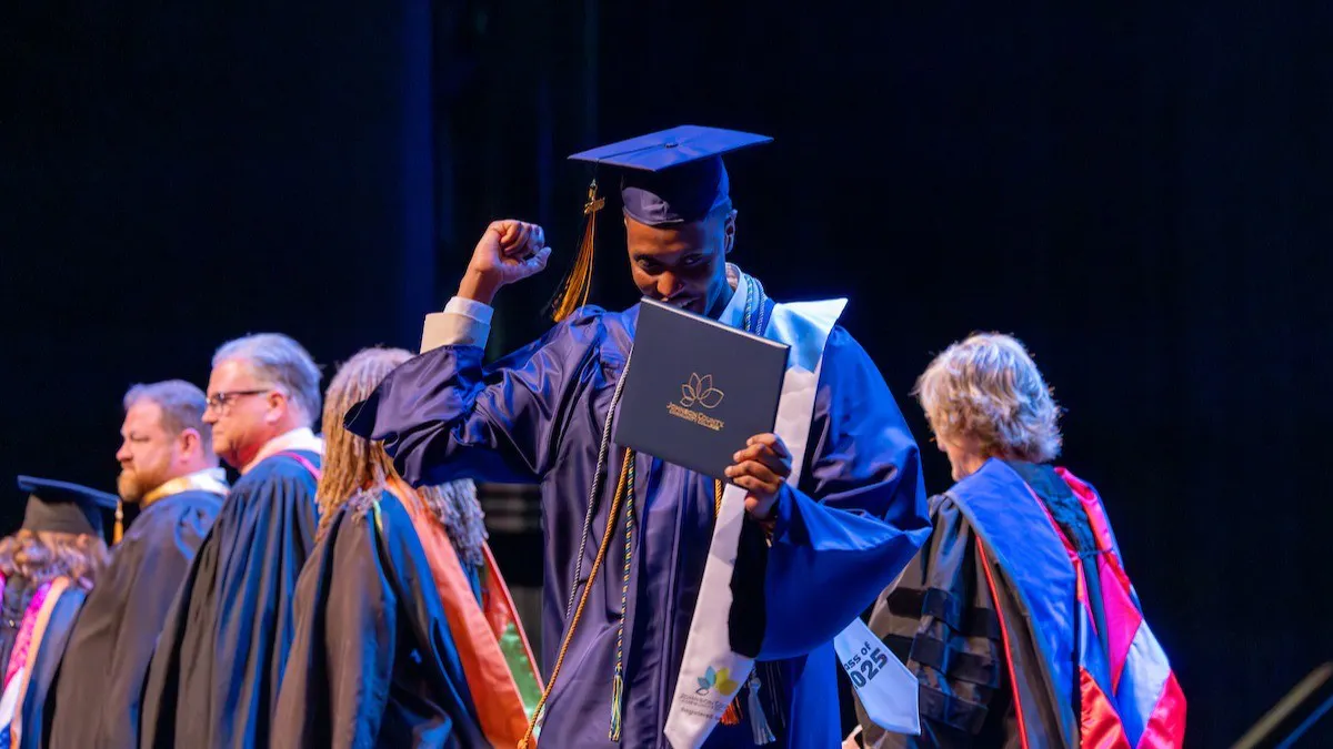Student receiving diploma at JCCC graduation ceremony