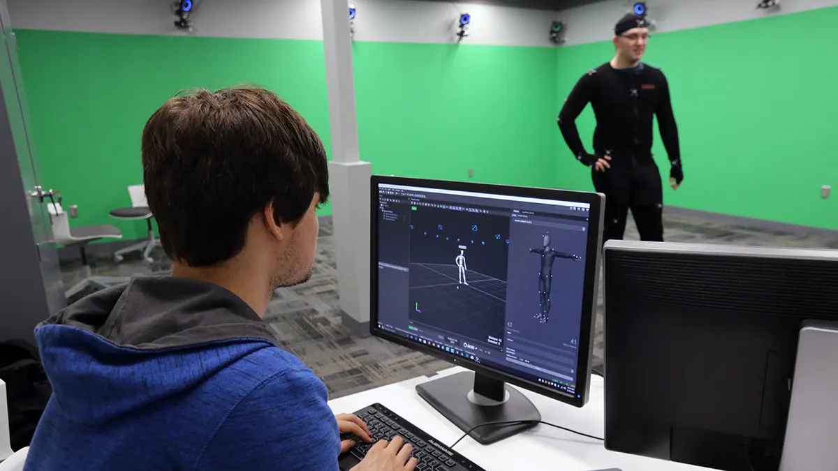 Student works on a computer to capture another student's actions in JCCC's motion capture studio.