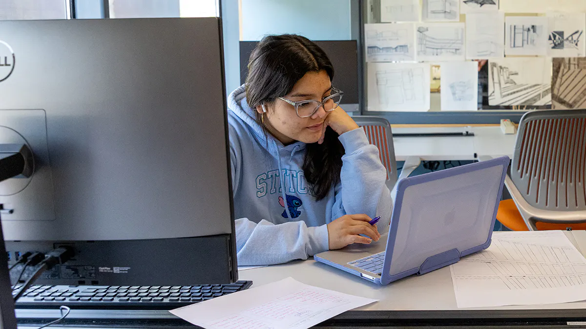 Architecture student works on a project in a computer lab.