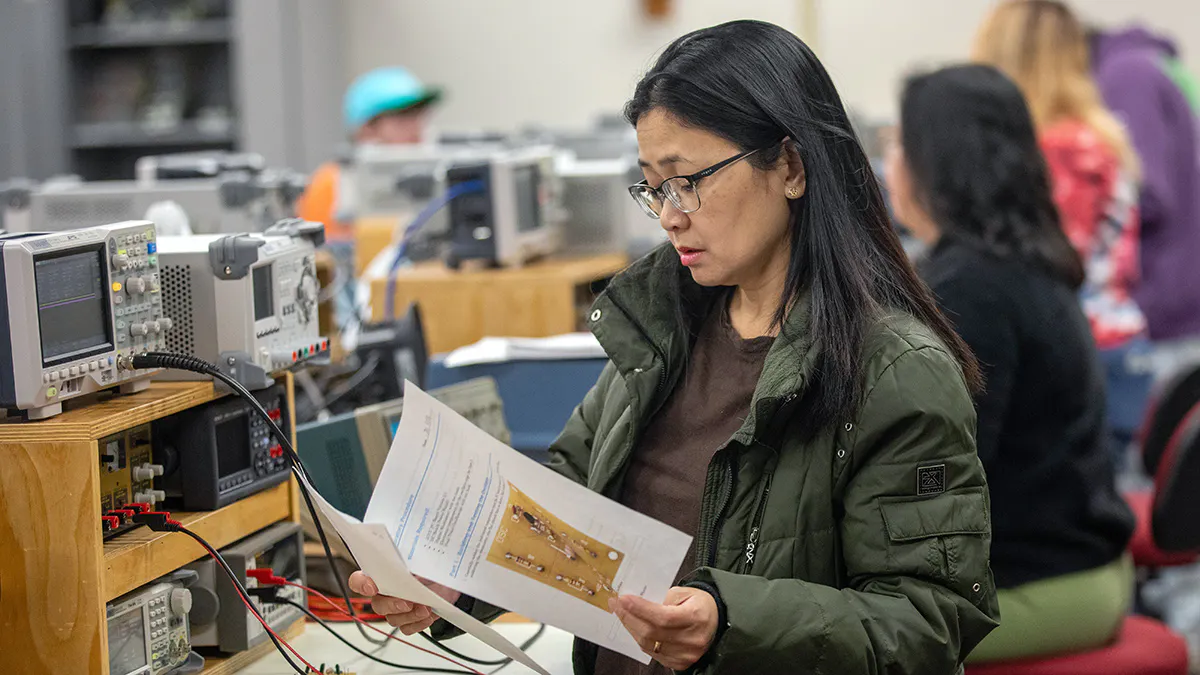 Student reviews and assignment in an electronics technology classroom.