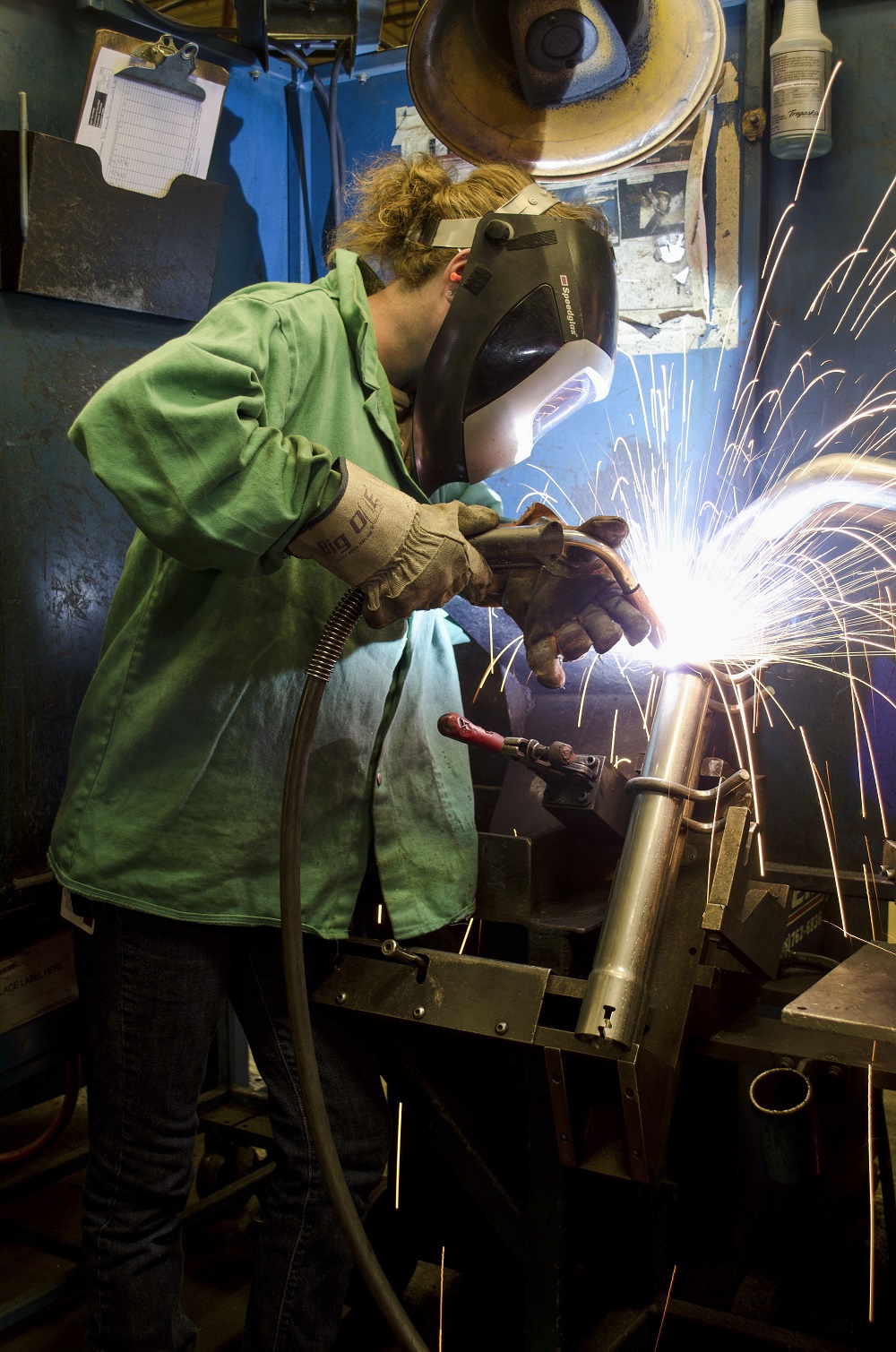A KCC welding graduate welds on the job
