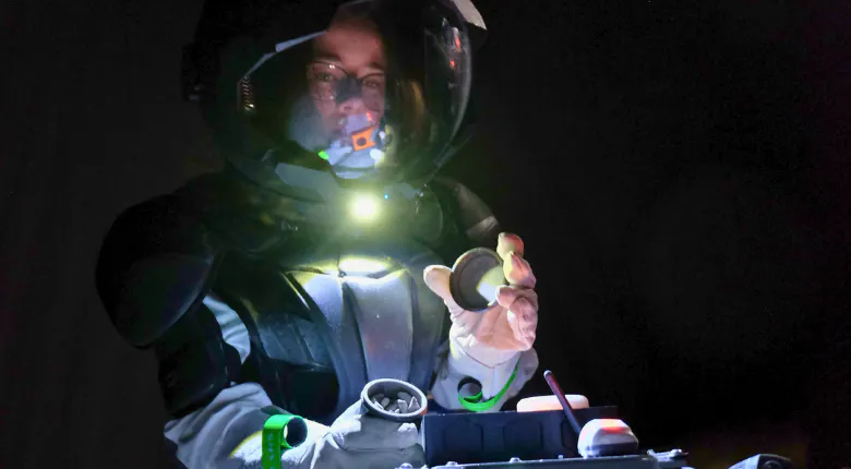 Young woman in a spacesuit using space tools.