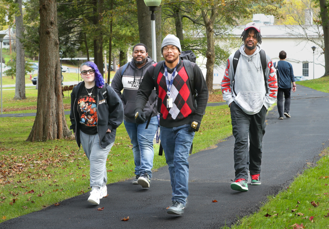 Four students walking outside