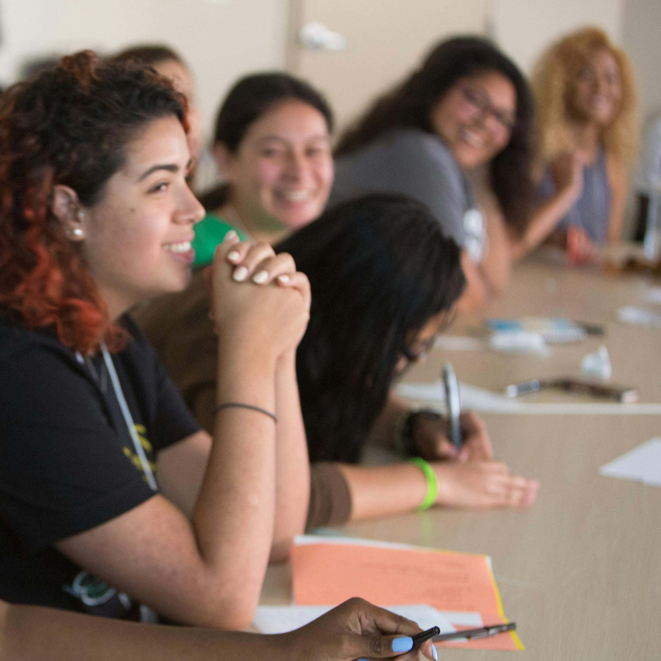 group of students in classroom listening to professor