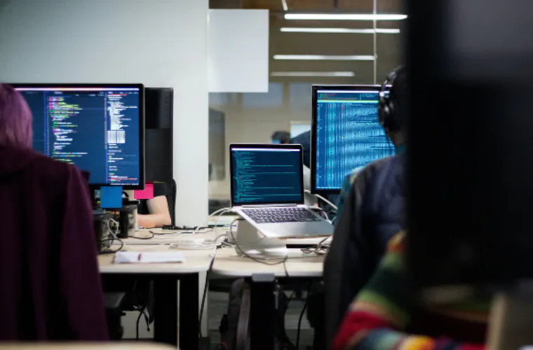 Data scientists work on coding in a computer lab.