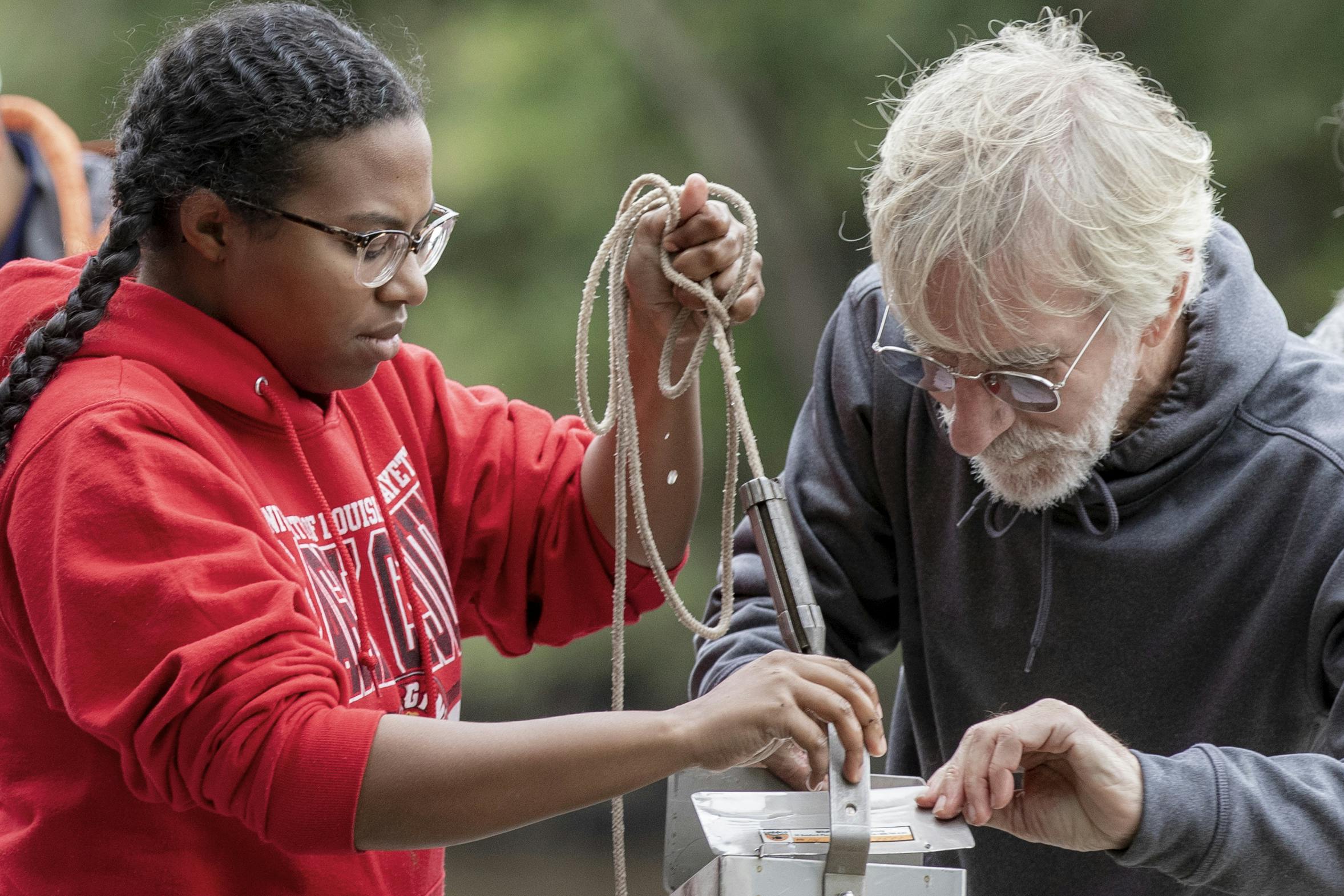 A UL Lafayette professor works with a student to conduct field research.