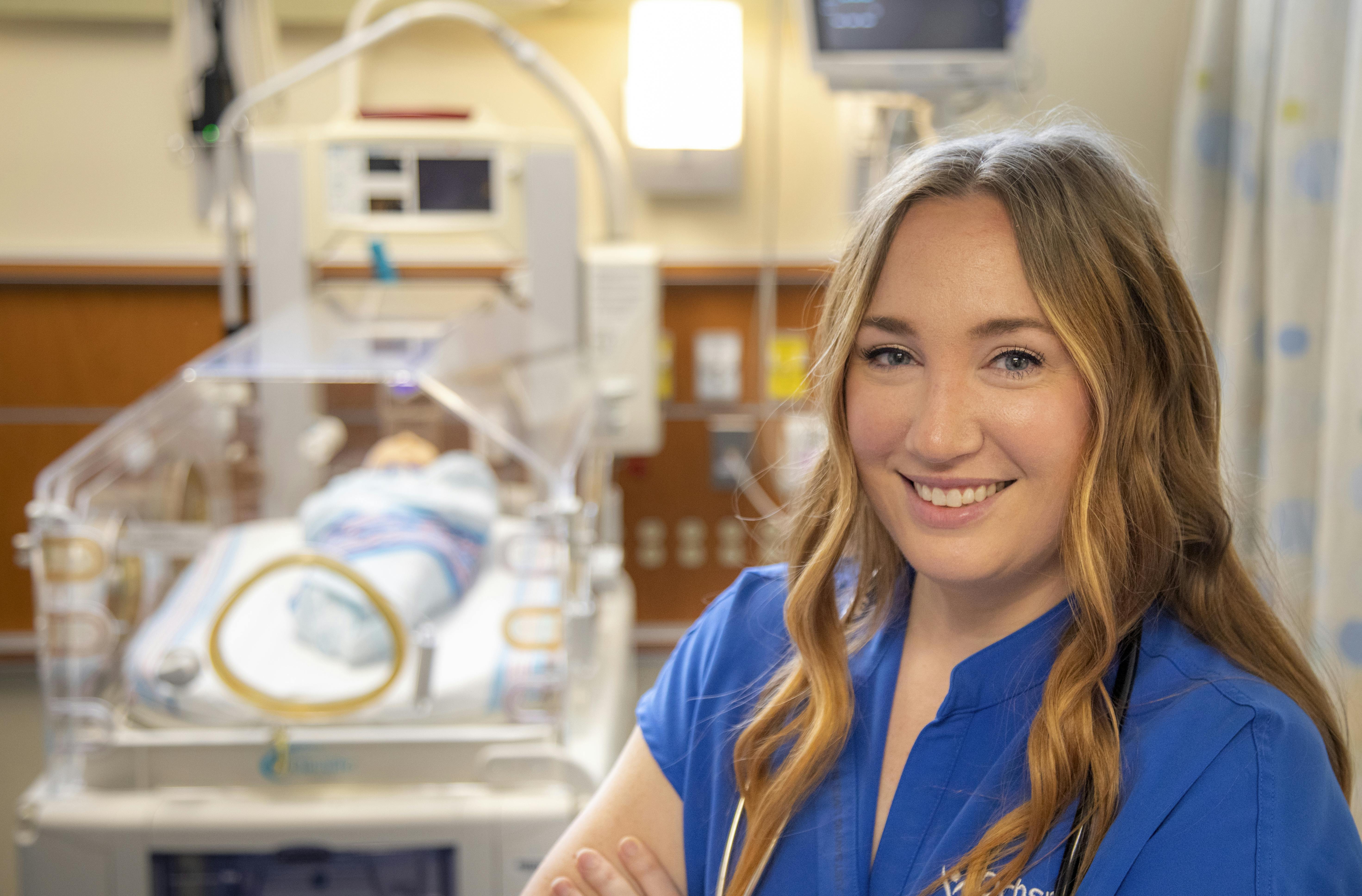 A UL Lafayette RN to BSN graduate poses in an area NICU. 