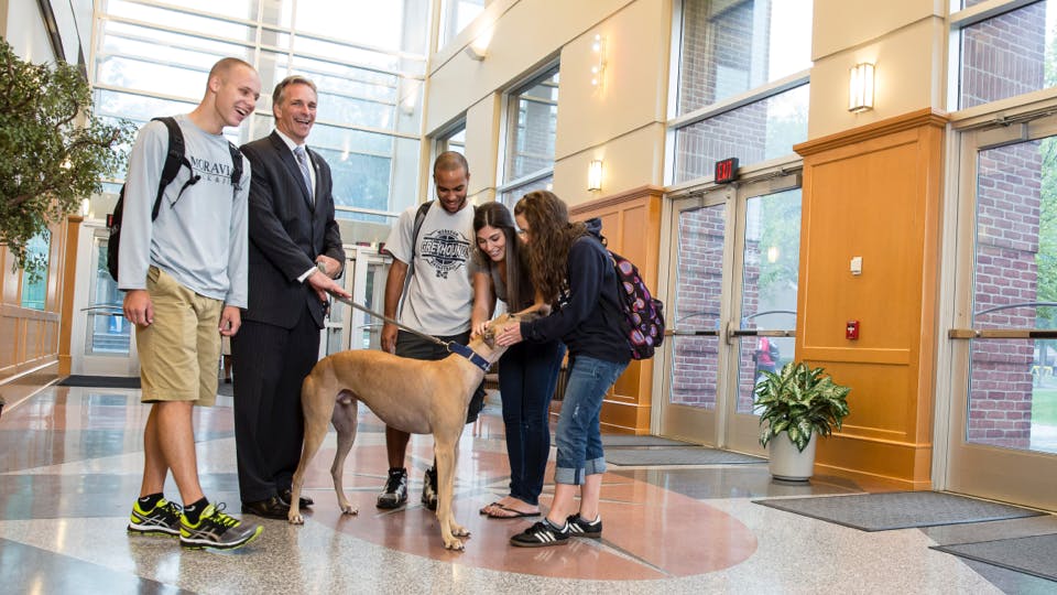 President with students and dog