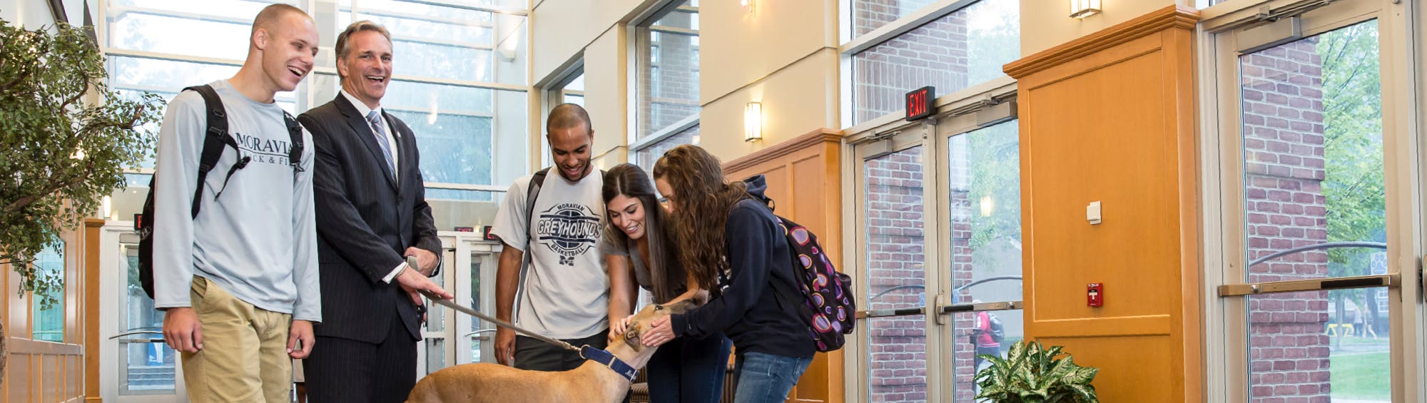 President with students and dog