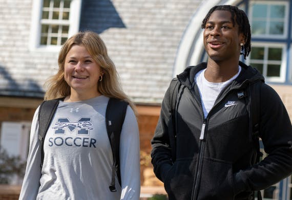 Two Moravian students walking on campus