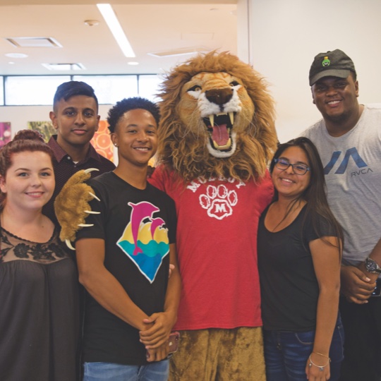 students and parent with mascot
