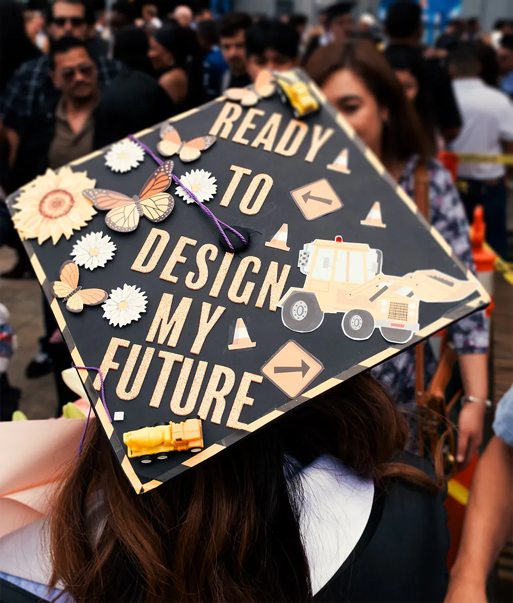 A graduation cap decorated to spell:" Ready to design my future"