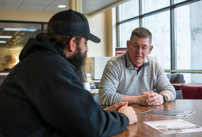 A student and advisor meeting together
