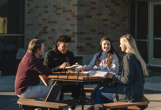 A group of students working on a project around a table
