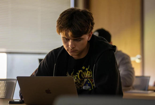Student studying at a laptop