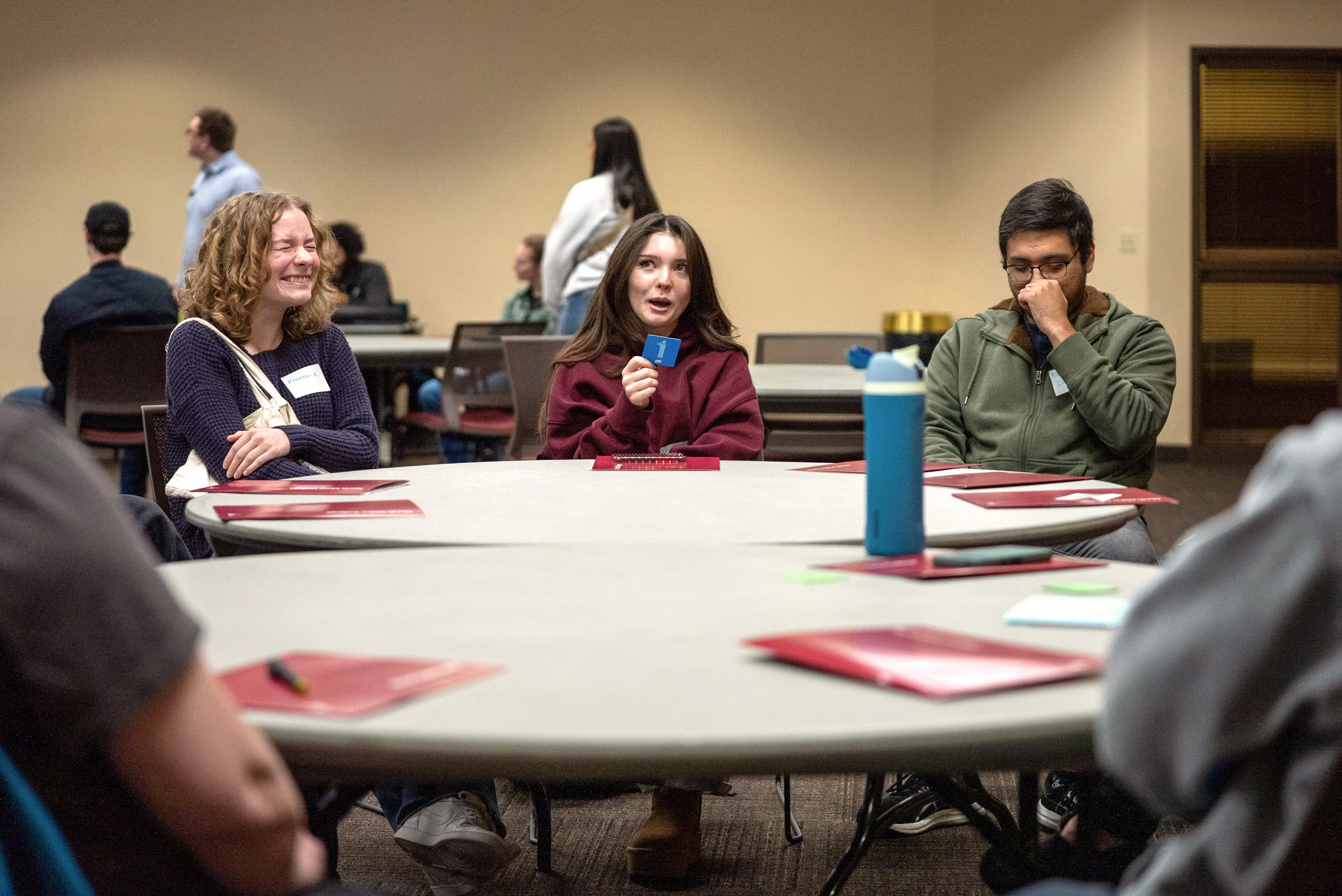 Students laughing around a table
