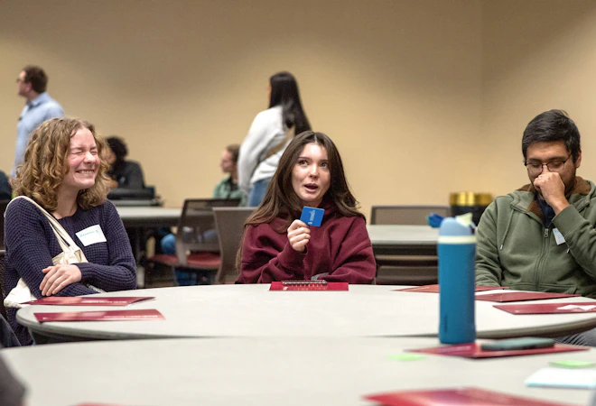 Students laughing around a table