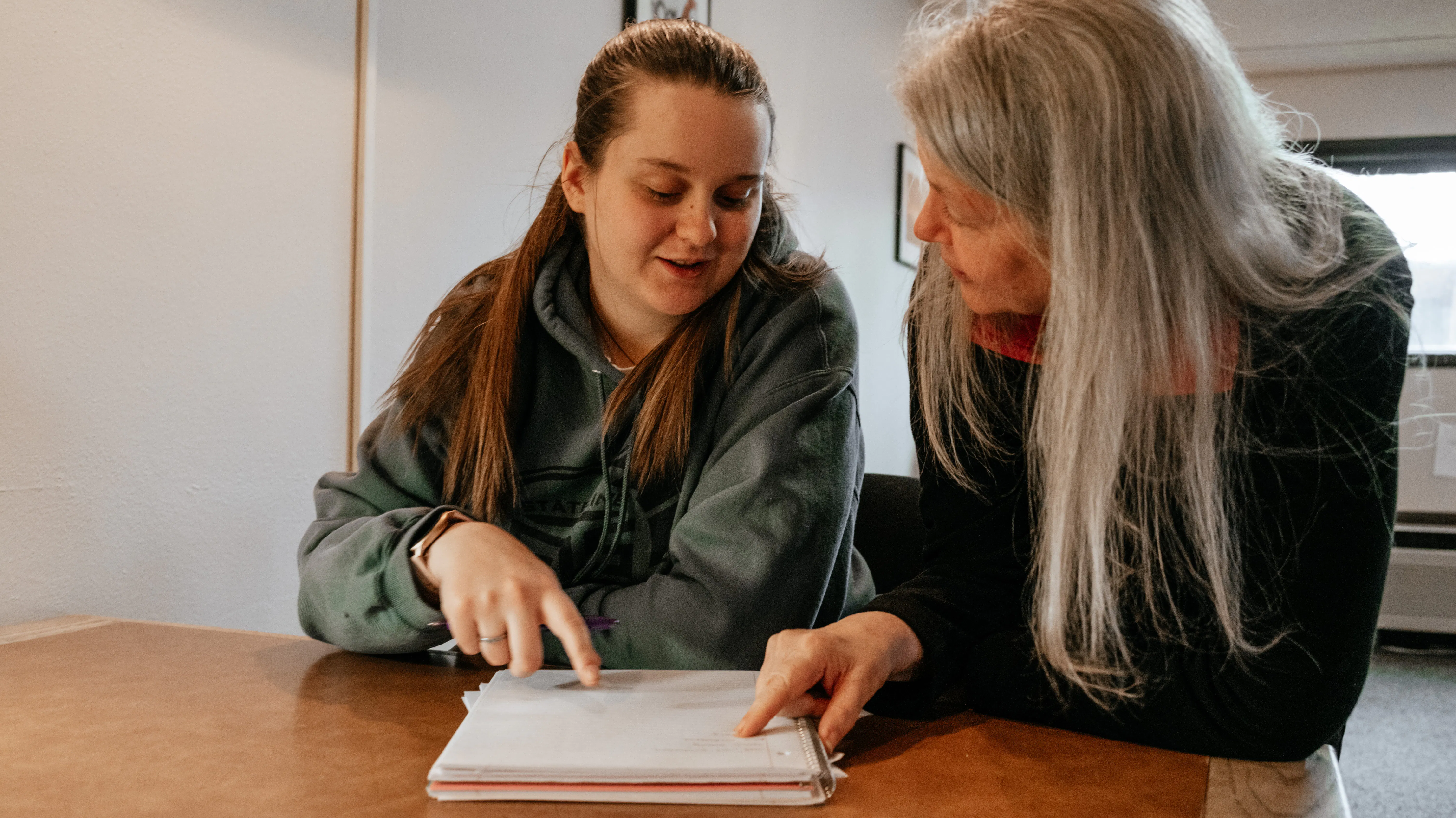 A student and instructor looking over a paper