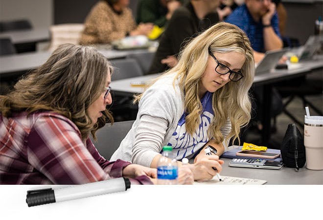 A student works with a professor at math colloquium.