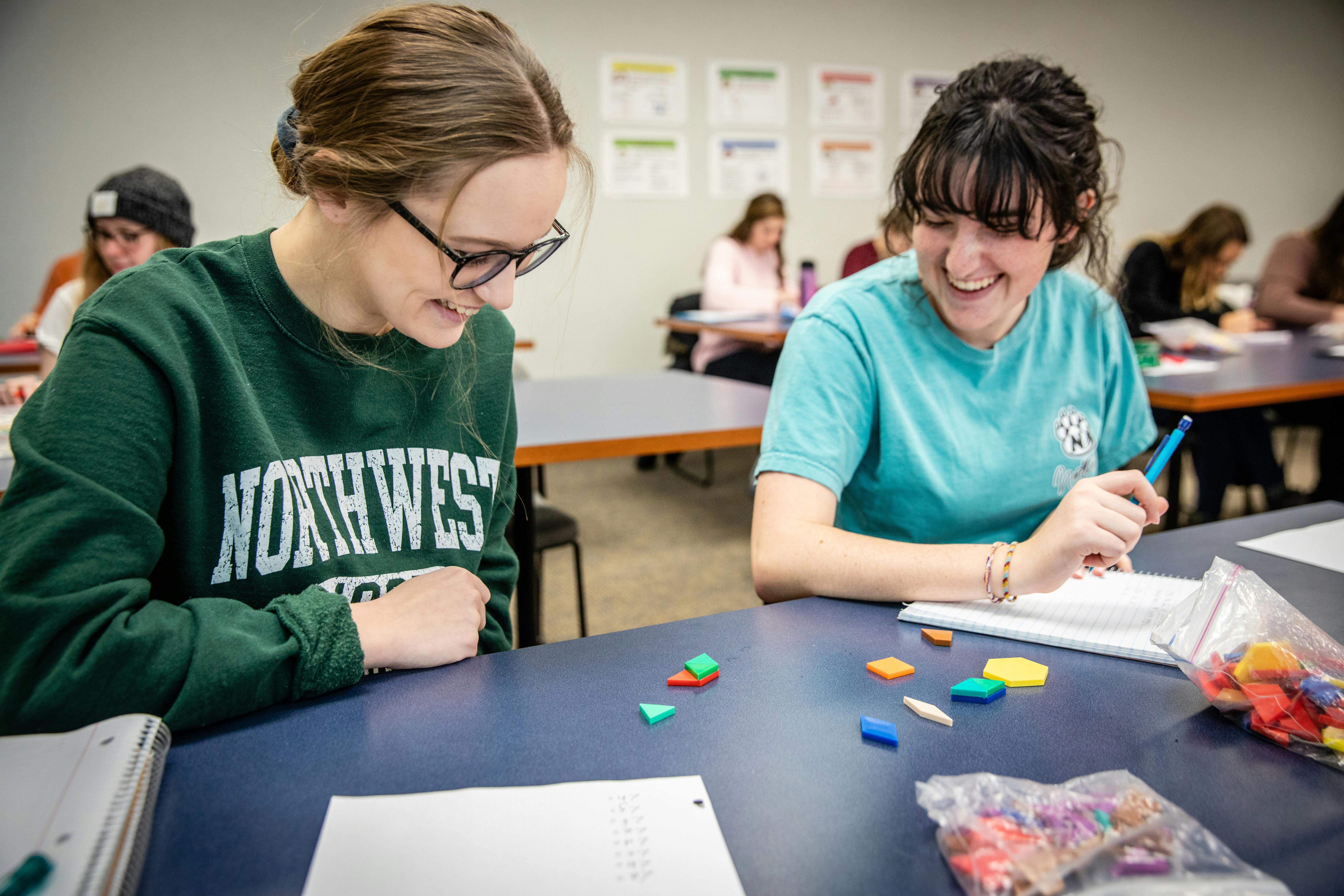 Two students work together to solve a problem.